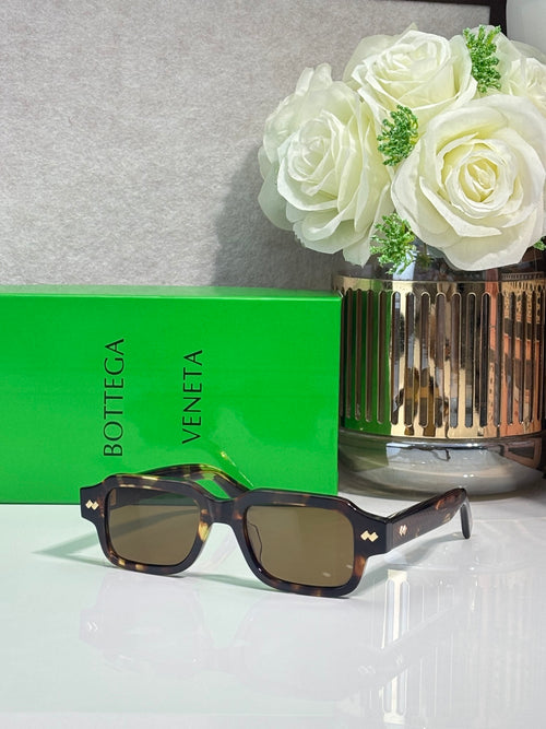 Bottega Veneta dark rectangular glasses with gold logo accents and square lenses