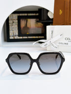 Black square sunglasses with dark lenses and gold hinge detail.