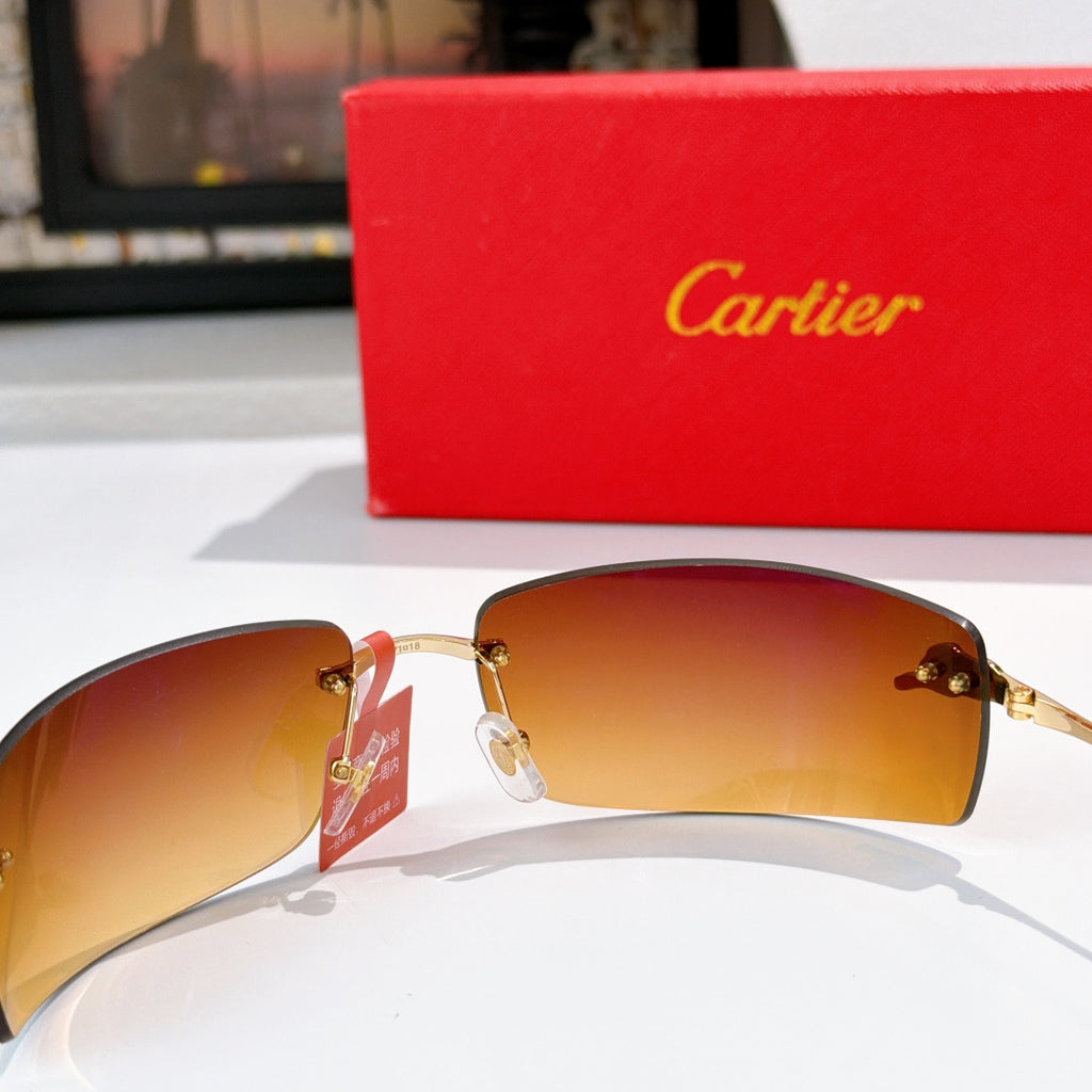 Cartier sunglasses close-up with gold frame and amber tinted lenses