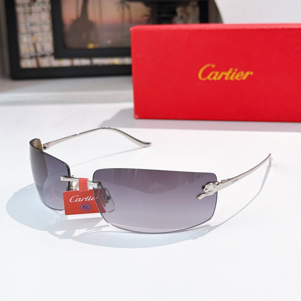 Cartier sunglasses with gold frame and dark gray tinted lenses, front angle