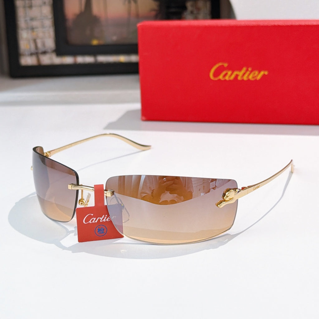 Cartier sunglasses with gold frame and clear-to-tinted lenses, label on temple