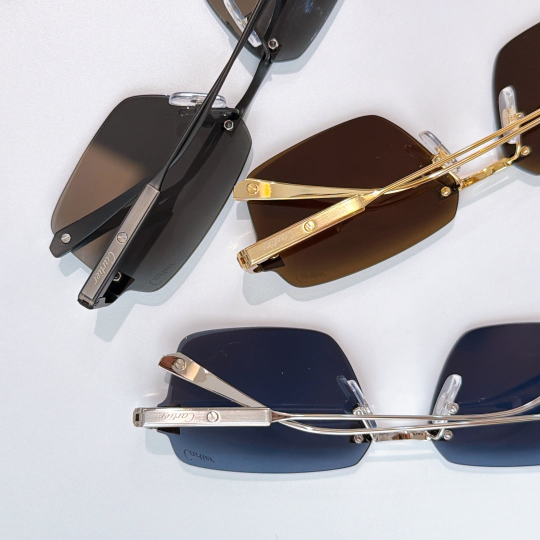 Multiple rectangular sunglasses with different colored lenses and metal frames, side view.