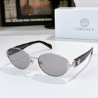 Sunglasses with gold frame, gray lenses, and black temple arms