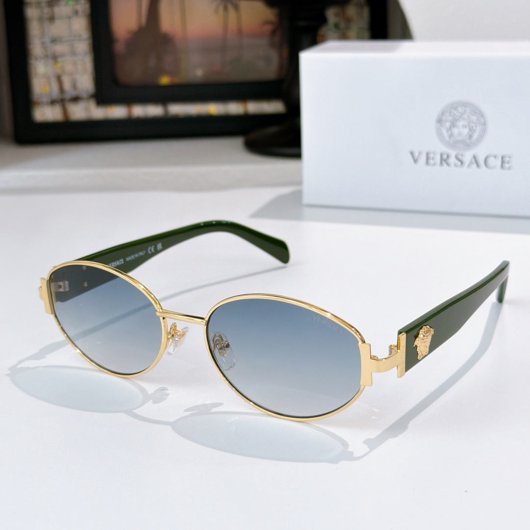 Versace sunglasses with gold frame, blue lenses, and green temple tips