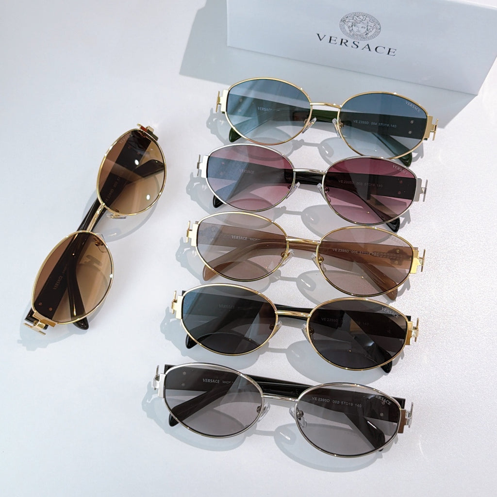 Group of sunglasses with gold frames and tinted lenses on display