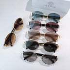 Group of sunglasses with gold frames and tinted lenses on display
