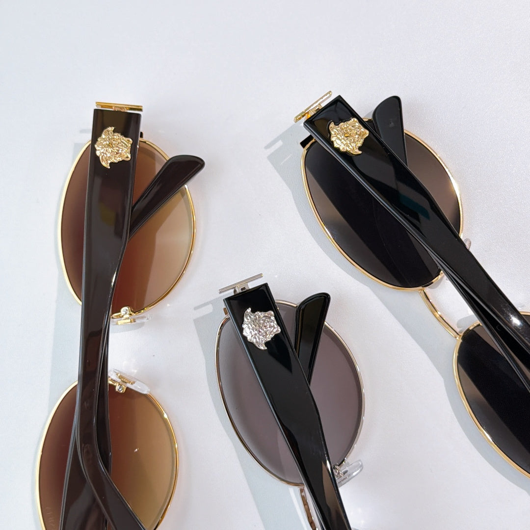 Assorted sunglasses with gold details and tinted lenses, shown close up