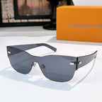 Louis Vuitton sunglasses with dark gray frames, wide lenses, and gold-tone logo detail.