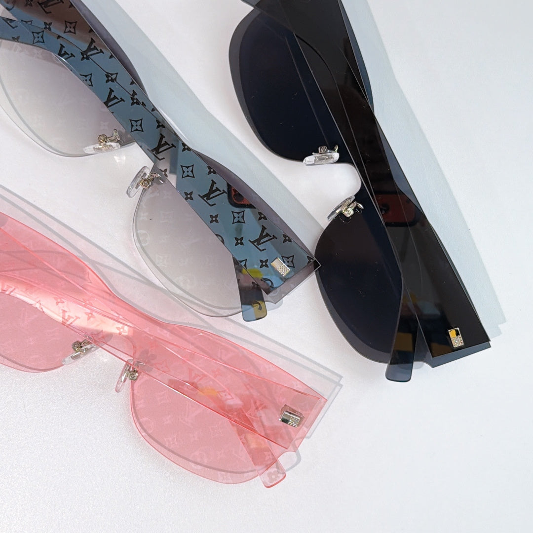 Louis Vuitton sunglasses close-up showing pink, white, and dark frames with gold-tone hardware.