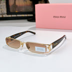Designer sunglasses with tan gradient lenses, gold frame, and black temple tips
