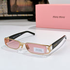 Designer sunglasses with pink-tinted oval lenses, gold frame, and black temple tips