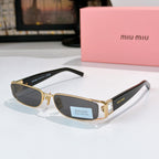 Designer sunglasses with dark oval lenses, gold frame, and black temple tips