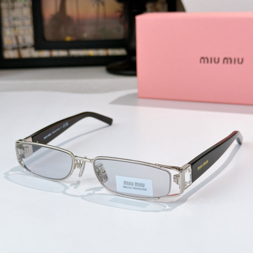 Designer eyeglasses with clear oval lenses, silver frame, and dark-stamped black temples