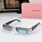 Designer eyeglasses with light blue-tinted oval lenses, silver frame, and black temples