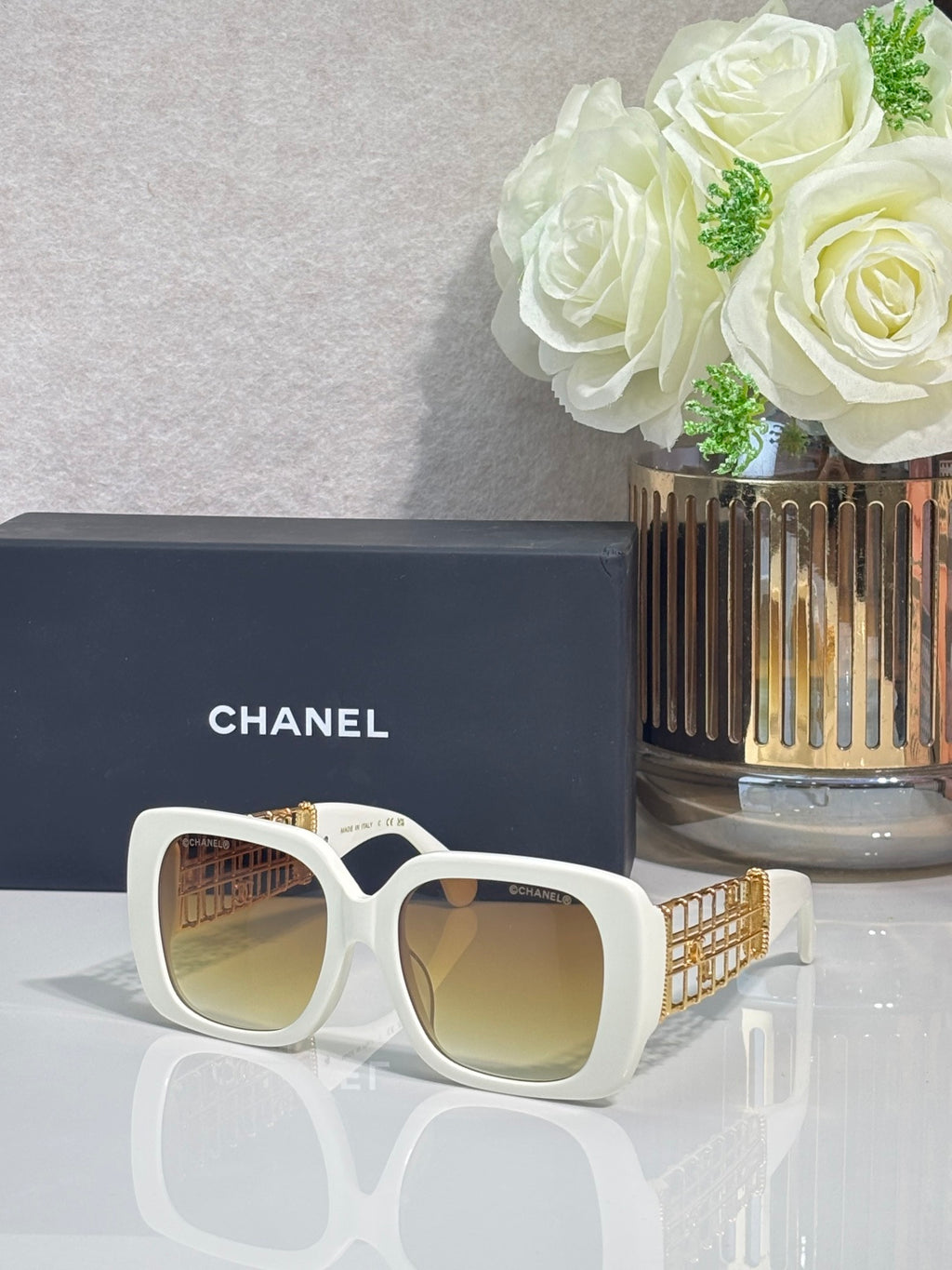 Chanel sunglasses with white frame and gold-tinted lenses