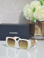 Chanel sunglasses with white frame and gold-tinted lenses