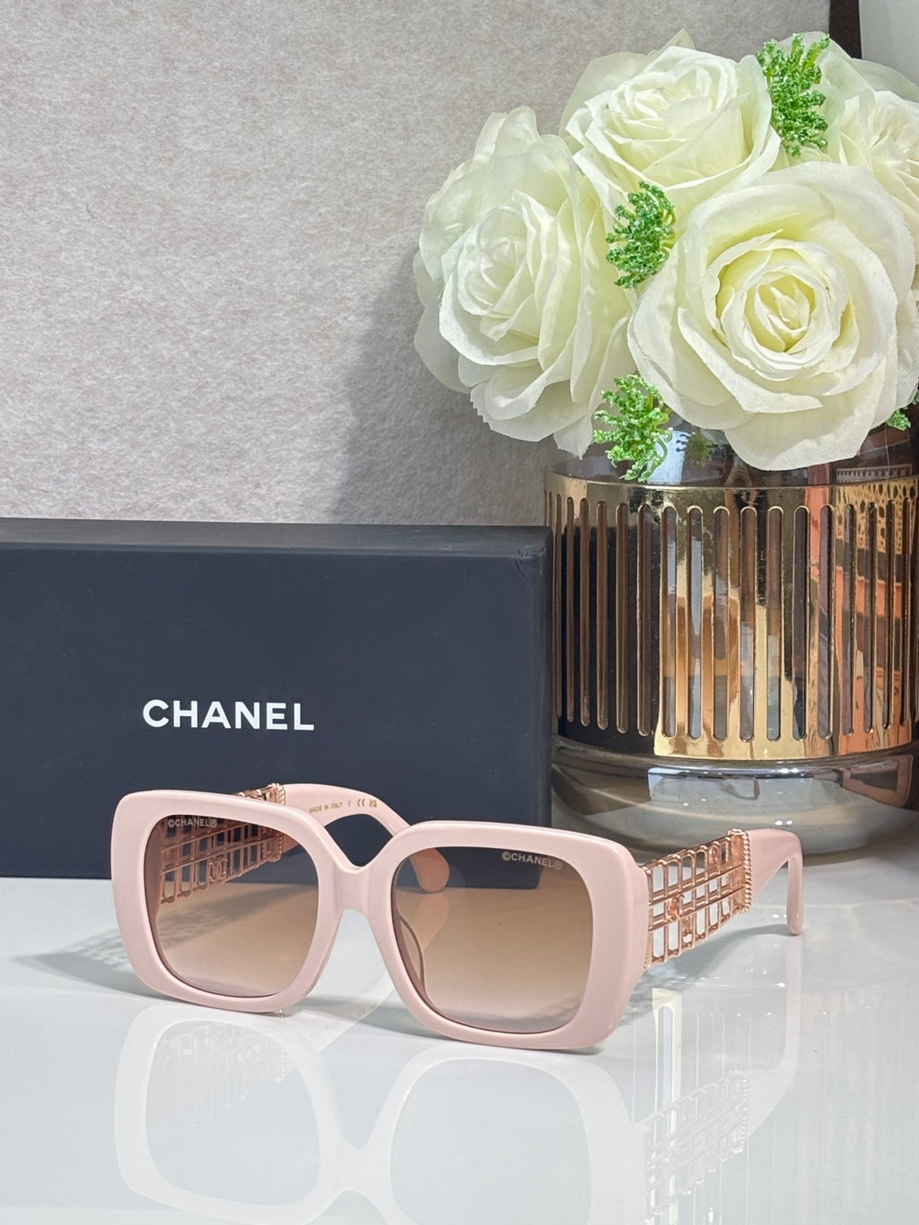 Chanel sunglasses with light pink frame and beige lenses