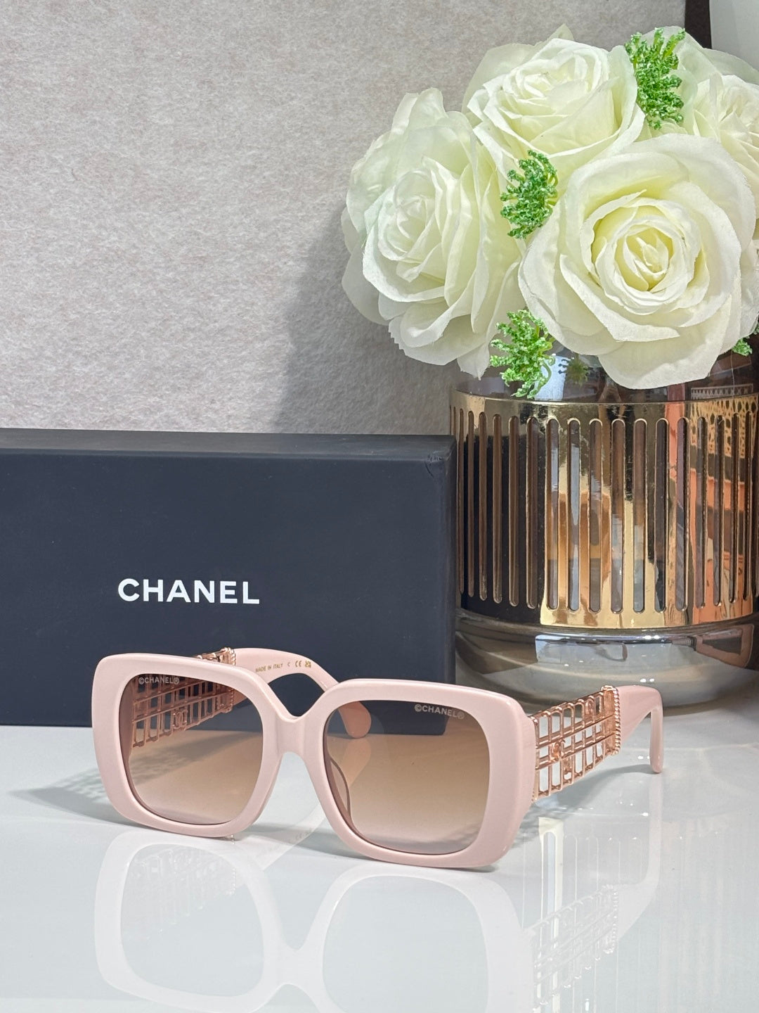 Chanel sunglasses with light pink frame and beige lenses