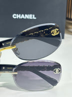 Chanel sunglasses close-up of dark lenses with gold chain temple details