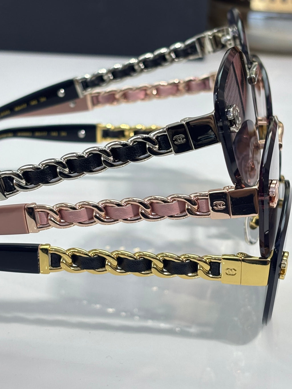 Chanel sunglasses close-up of metal temples with layered chain straps