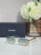 Chanel sunglasses with blue lenses, gold-trim frame and chain detail