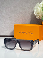 Dark blue square sunglasses with tinted lenses and gold-tone accents on hinges