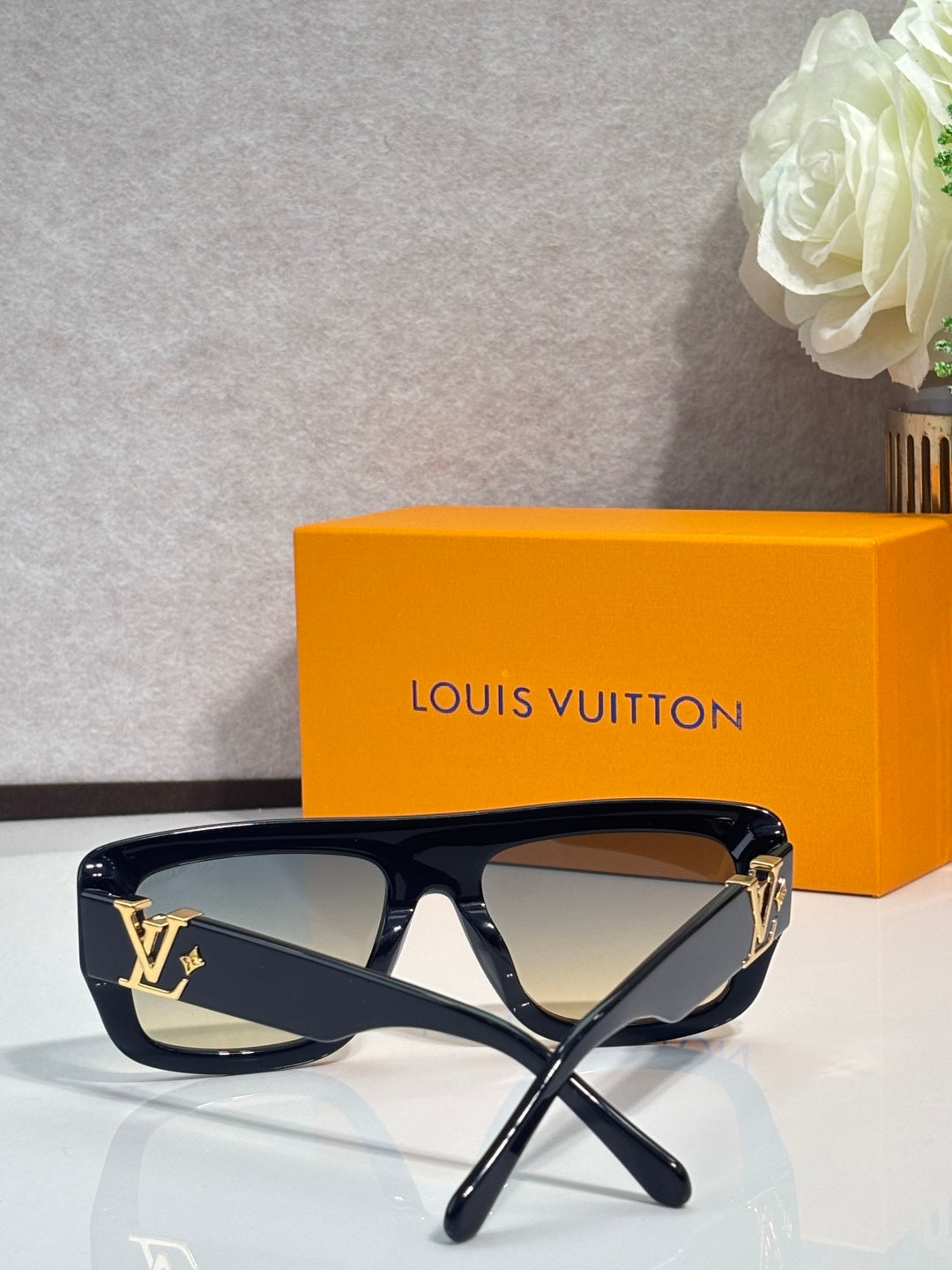 Dark navy square sunglasses with tinted lenses and gold LV logo on temples
