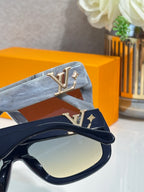 Blue sunglasses with gold LV emblem on temple strap and tinted lenses