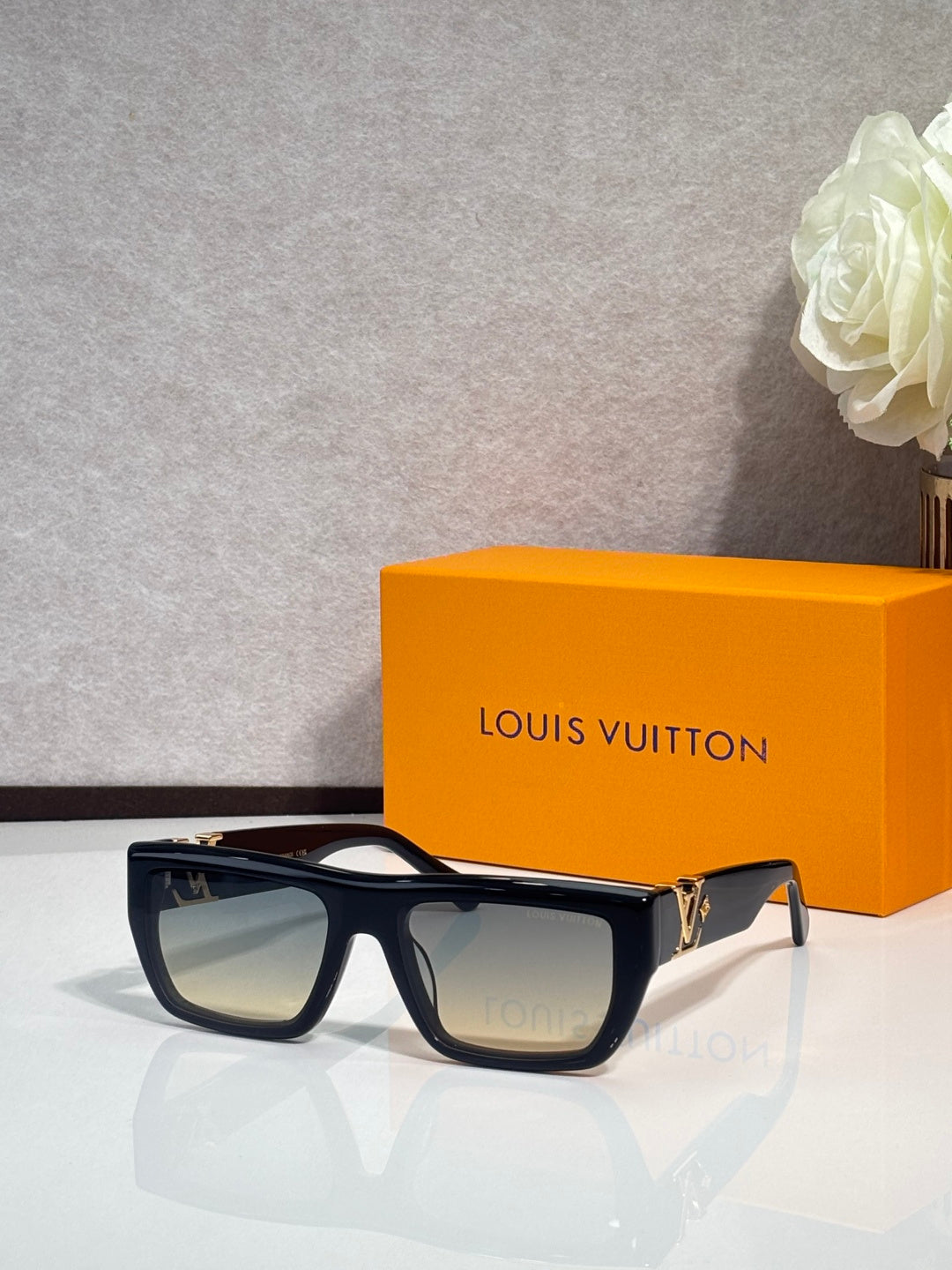 Louis Vuitton sunglasses with dark frame and tinted lenses, front view