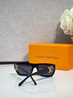 Louis Vuitton sunglasses with black frame and patterned gold-tone side details