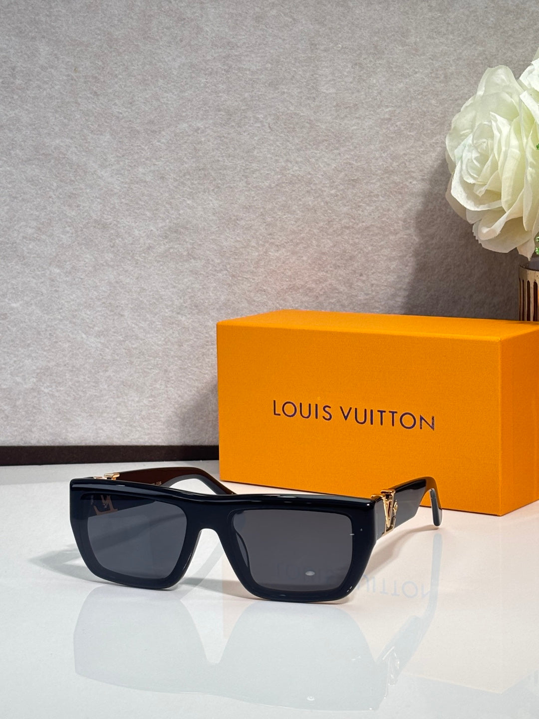 Louis Vuitton sunglasses with dark frame and large rectangular tinted lenses