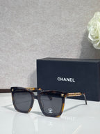 Chanel cat-eye sunglasses with dark tortoiseshell frames and dark lenses