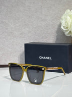 Chanel square sunglasses with yellow-gold frames and dark lenses
