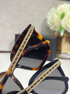 Chanel square sunglasses with tortoiseshell frames, gold rhinestone accents, and dark lenses