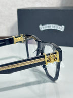 Chrome glasses with gold-tone hinge and dark frame temple, ornate crest detail