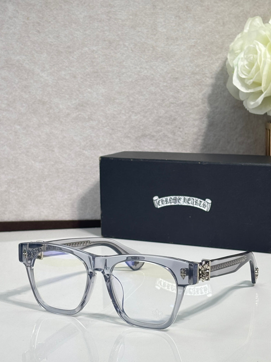 Chrome glasses with light silver rectangular frames and gold accent temple hardware