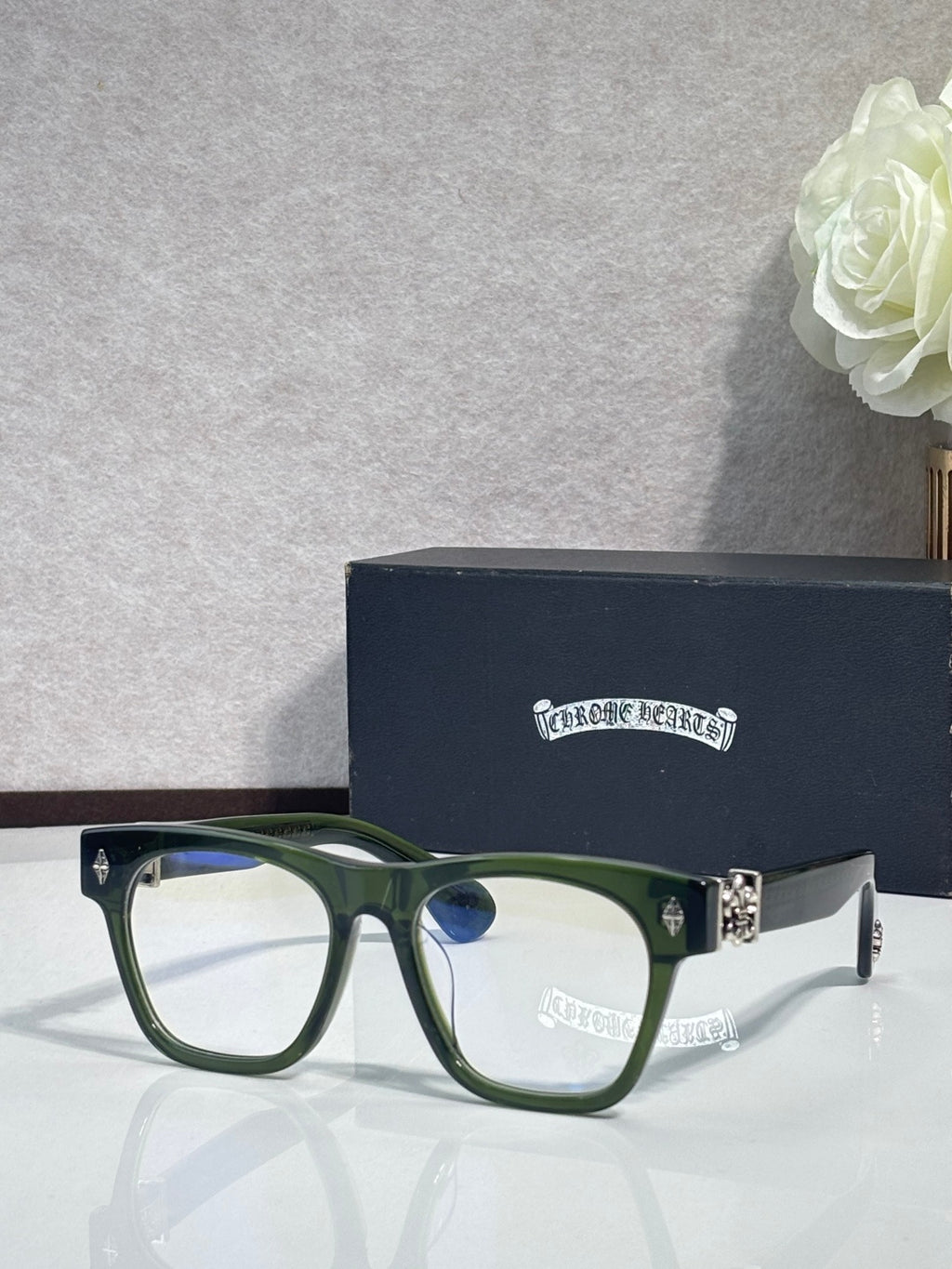 Chrome glasses with dark green square frames, blue lens tint, and rhinestone hinge