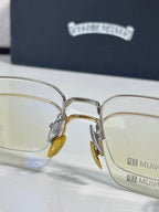 Front view of gold and silver eyeglass frames with clear lenses and amber temple tips