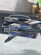 Silver-tone eyeglasses with clear lenses, stacked side view showing ornate temple ends