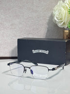 Black and silver-tone eyeglasses with clear lenses and ornate temple detail