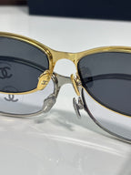 Chanel sunglasses, gold and dark frames, round lenses and logo bridge