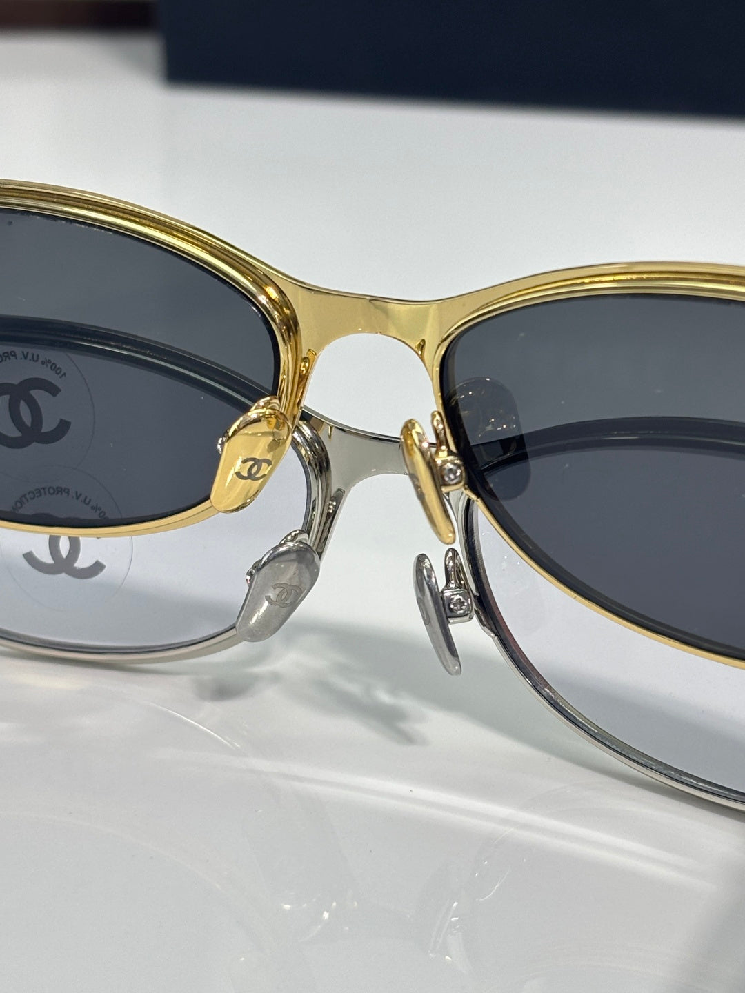 Chanel sunglasses, gold and dark frames, round lenses and logo bridge