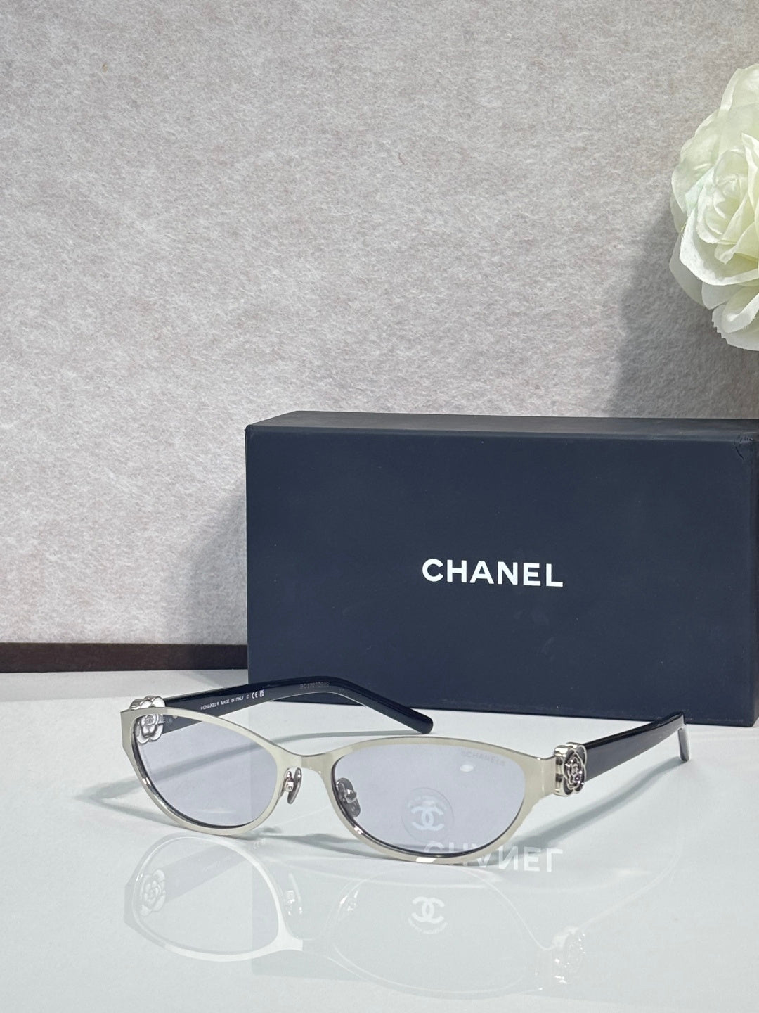 Chanel glasses, dark navy frames and clear lenses, metal logo details on temples