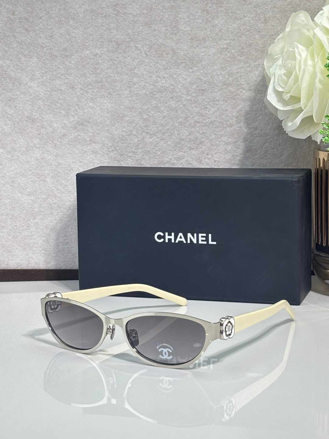 Chanel sunglasses, pale yellow frames and dark tinted lenses, ornate temple hardware