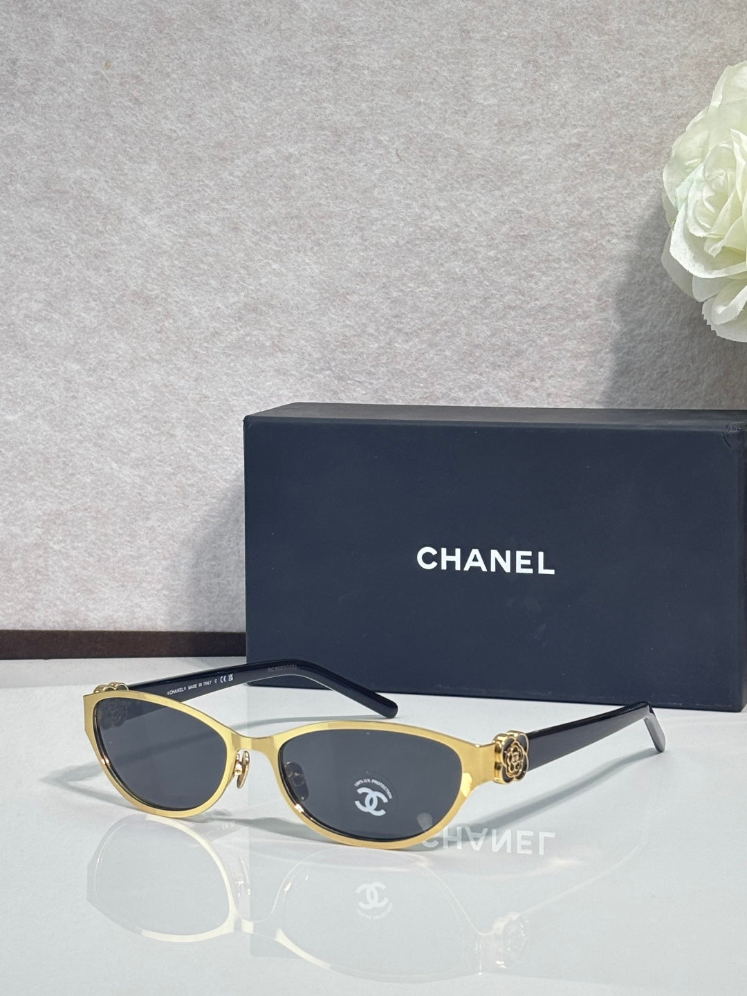 Chanel sunglasses, gold frames and dark lenses, decorative temple crest