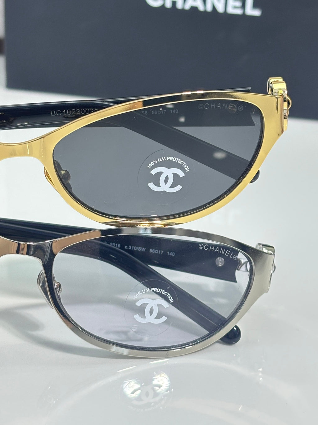 Chanel sunglasses, two-tone frames and dark lenses with Chanel emblem