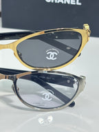 Chanel sunglasses, two-tone frames and dark lenses with Chanel emblem