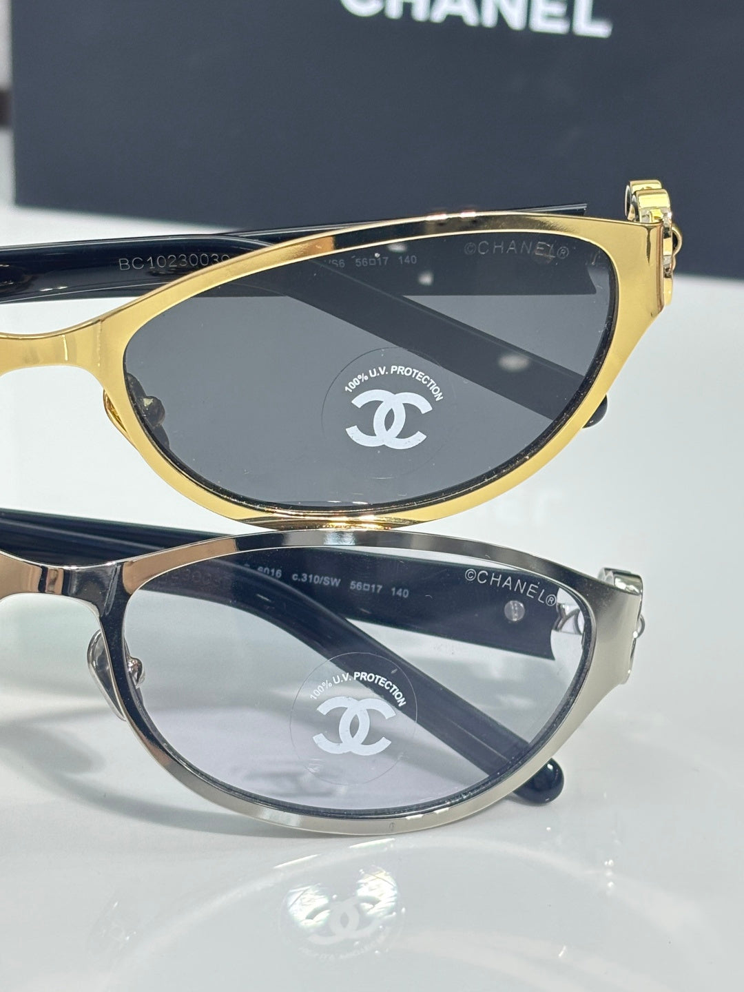 Chanel sunglasses, two-tone frames and dark lenses with Chanel emblem