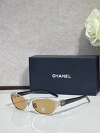 Chanel sunglasses, gold frames with amber lenses, metal logo on side