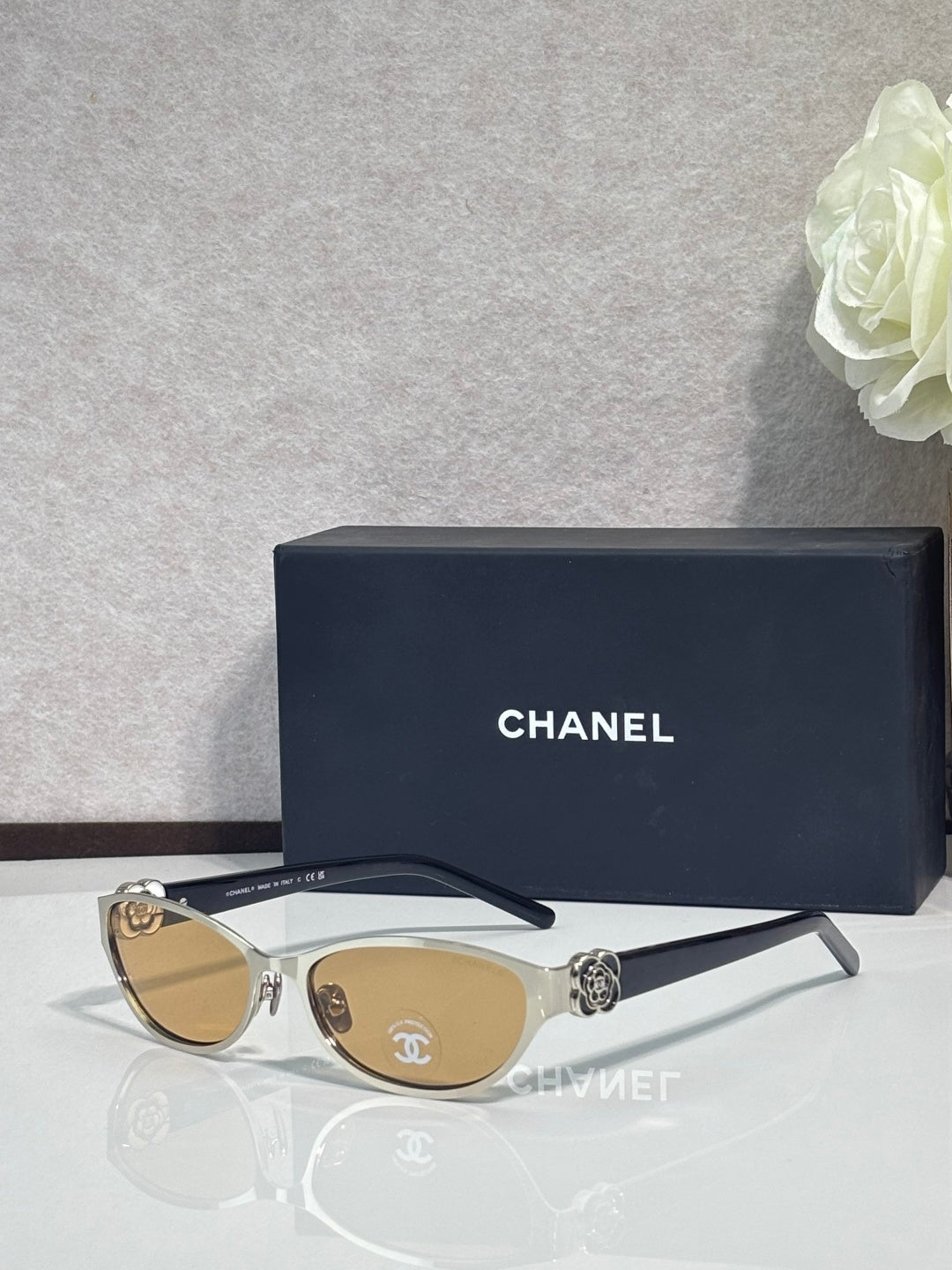 Chanel sunglasses, gold frames with amber lenses, metal logo on side